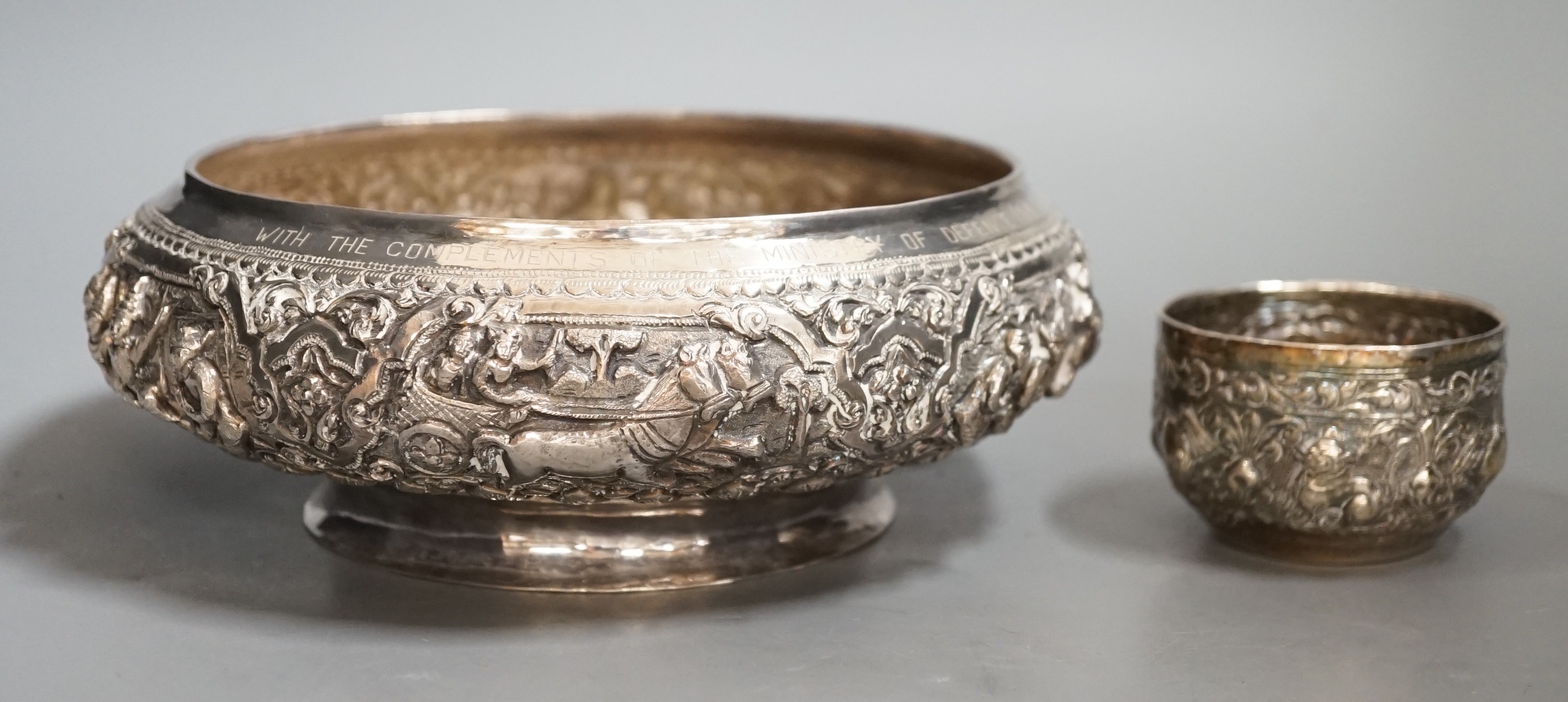 An Indian repousse white metal presentation bowl, with engraved inscription, diameter 21.5cm and a similar smaller bowl